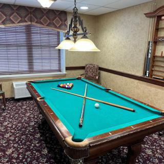 A cozy game room featuring a pool table set for play.