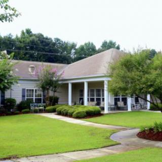 A suburban house with a well-maintained lawn and garden.