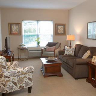 A cozy living room with comfortable seating and warm lighting.