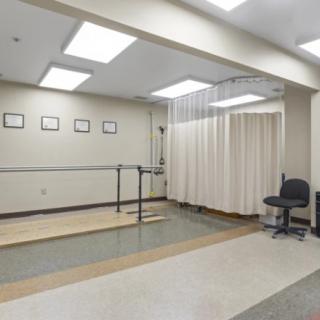 A rehabilitation room equipped with parallel bars for physical therapy exercises.