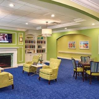 A cozy and modern living room with a fireplace, television, and comfortable seating arrangement.