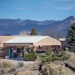A serene view of a southwestern style building surrounded by natural landscapes and mountains.