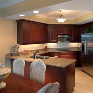 A beautifully designed modern kitchen featuring wooden cabinets, stainless steel appliances, and an inviting dining area.