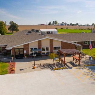 A rural facility with a large outdoor area on a sunny day.
