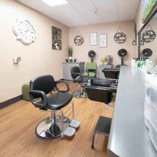 A cozy hair salon interior featuring styling chairs and a relaxing atmosphere.