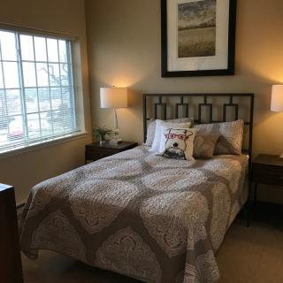 Cozy bedroom with elegant decor and warm lighting.