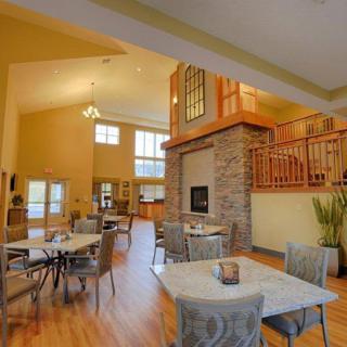A spacious and modern dining area featuring a cozy fireplace and elegant decor.