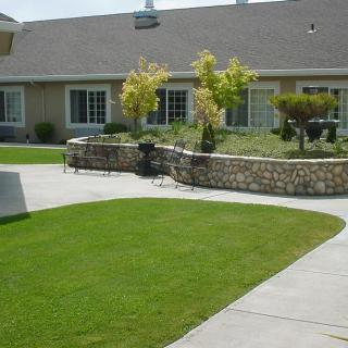 A well-maintained lawn and garden in front of a house.
