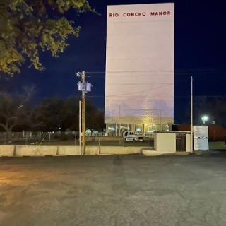 A tall building illuminated at night.