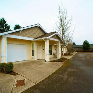 A suburban house with a driveway and surrounding yard.