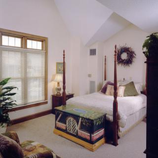 A cozy bedroom with a four-poster bed and elegant decor.