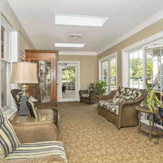 A cozy living room with ample natural light and comfortable seating.