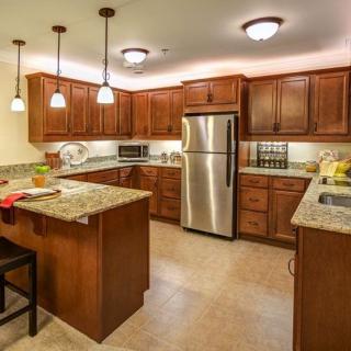 Modern kitchen with wood cabinets and stainless steel appliances.