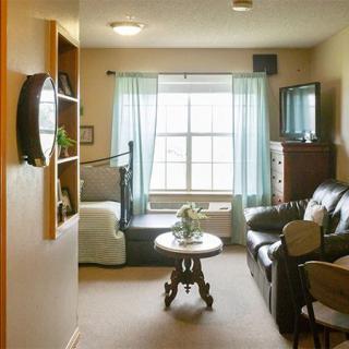 Cozy living room with a large window, sofa, and TV.