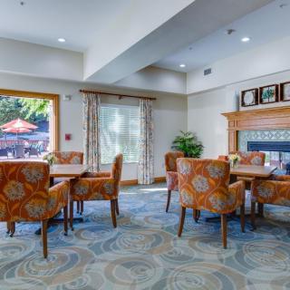 A cozy dining area with patterned chairs and abundant natural light.