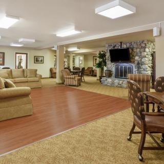 A spacious living room with comfortable seating and a large television.