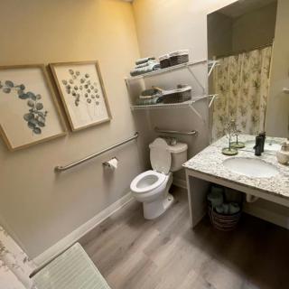 A neatly organized bathroom with decorative elements and ample storage space.