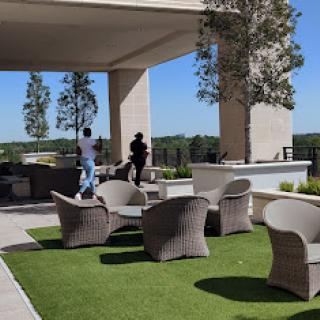 A serene outdoor seating area featuring stylish furniture and a beautiful landscape.