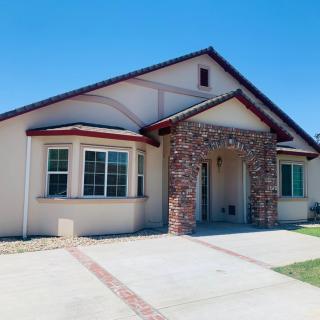 A single-story suburban house with a brick entrance and well-maintained exterior.