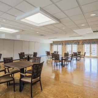 A spacious dining area with wooden floors and ample natural light.