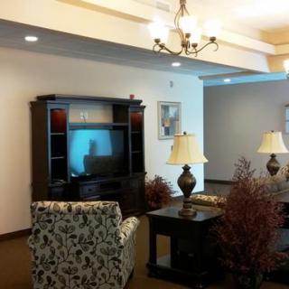 A cozy living room with classic furniture and a TV setup.