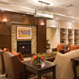 A cozy living room featuring a fireplace, modern decor, and comfortable seating.