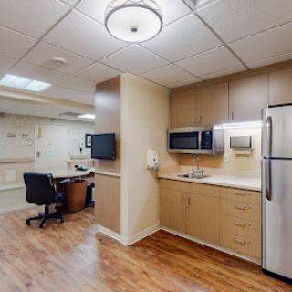 A well-equipped kitchenette area in a hospital room.