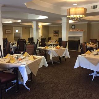 A cozy dining room set with tables and chairs, ready for guests.