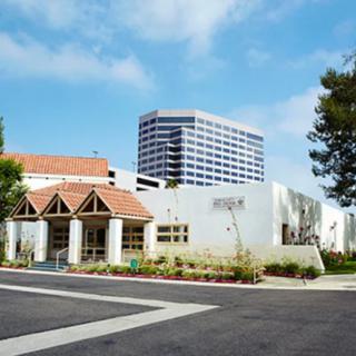 A modern building in an urban setting with clear skies.