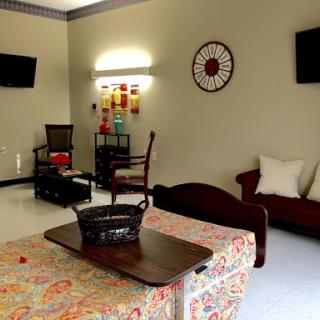 A cozy living room setup featuring comfortable seating, decorative elements, and entertainment options.
