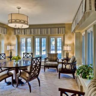 A beautifully arranged dining room with elegant furniture and ample natural light.