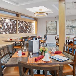 A modern restaurant dining area with neatly arranged tables and vibrant decor.