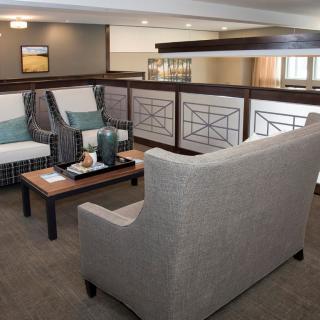A modern interior seating area with comfortable sofas and a coffee table.