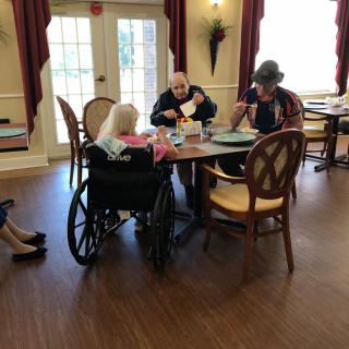 Elderly individuals enjoying a meal together in a community dining area.