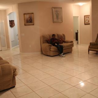 A cozy living room with tiled floors and comfortable seating.