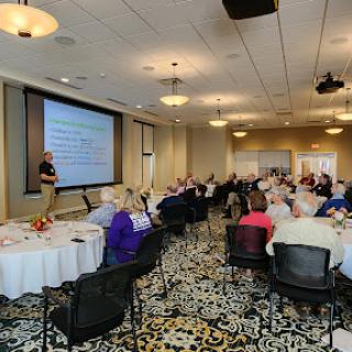 A speaker presents to an attentive audience during a conference.
