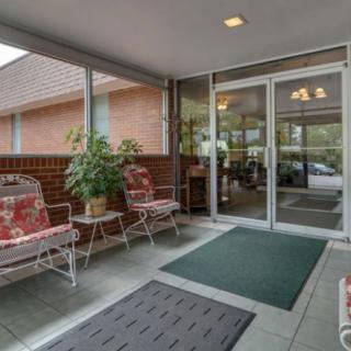 A welcoming entrance area with seating and greenery.