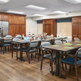 A spacious kitchen and dining area with wooden cabinets and various seating arrangements.