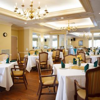 A beautifully arranged dining room featuring elegant tables and comfortable seating, perfect for formal gatherings.
