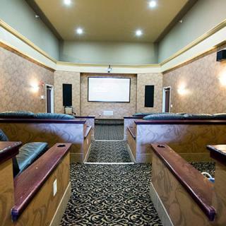 A luxurious home theater room with comfortable seating and a large projector screen.