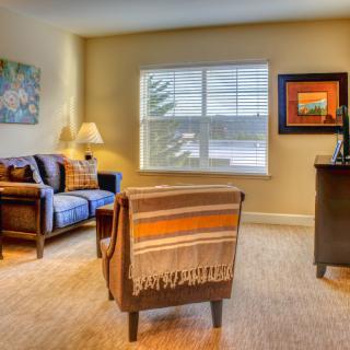 A cozy living room with comfortable seating and warm lighting.
