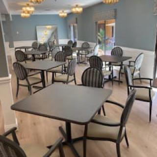 An empty dining area with multiple tables and chairs arranged neatly.