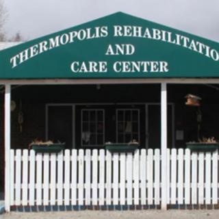 Entrance of Thermopolis Rehabilitation and Care Center with a white picket fence.