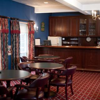 Cozy bar area with dark wood furnishings and a warm atmosphere.