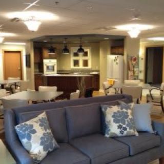 A modern open-space living room and kitchen area with contemporary decor.
