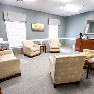 A cozy waiting room featuring comfortable chairs and a serene color palette.