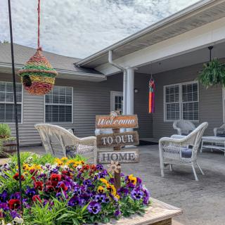 A cozy patio with colorful flowers and welcoming decor.