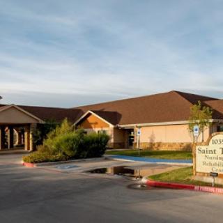 A view of a residential building with a welcoming entrance and landscaped surroundings.