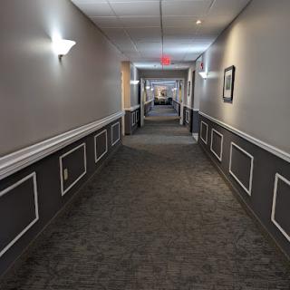 A well-lit hotel hallway showcasing a clean and modern design.
