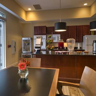 A modern kitchen and dining area with sleek design and contemporary lighting.